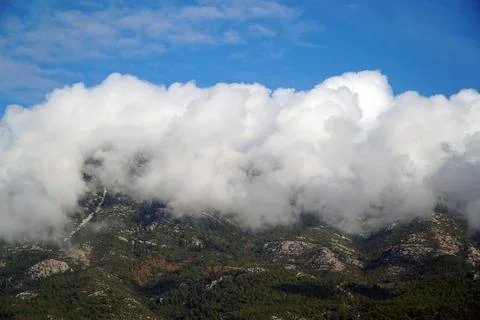 Clouds on the tops of the mountains. Clouds in the mountains. Stock Photos