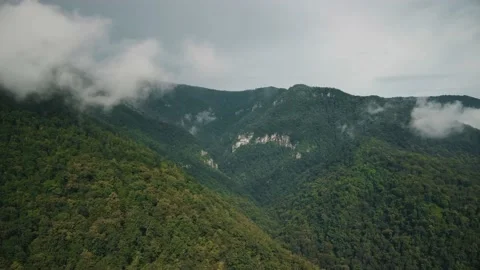 Clouds touch the top of the mountain view from above Video stock 201293662