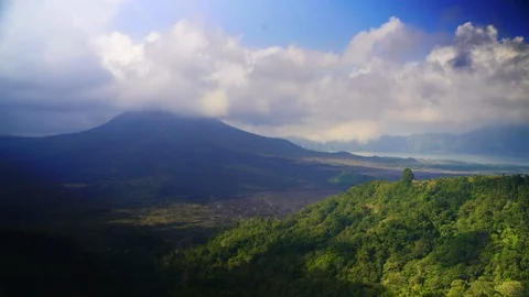 Clouds travel over the volcano Mount Agung in northern Bali timelapse Stock Footage 124996964