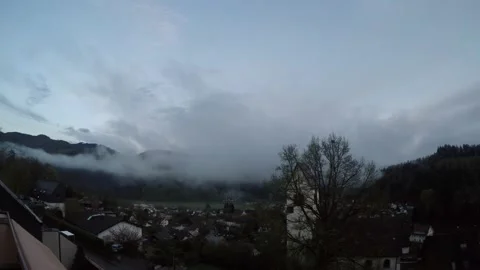 Clouds in a valley at dusk Stock Footage 240182504