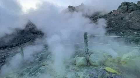 Clouds of volcanic steam drifting over a rope fence Stock Footage 221888122
