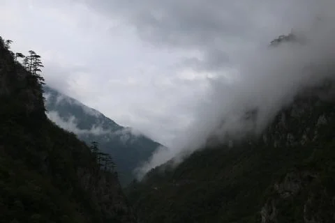 Clouds walk between the mountain 写真素材