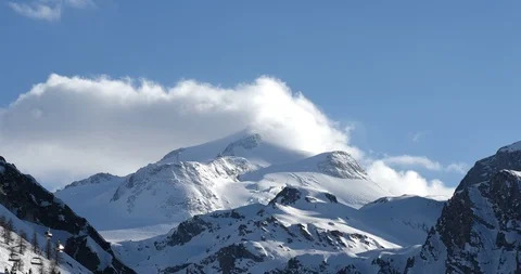 Clouds weather front moving in over ski resort snowy mountain top 動画素材 96082232