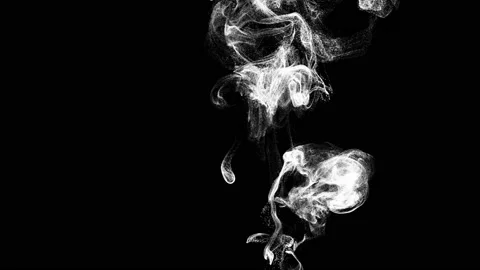 Clouds of white smoke on a black background rise upwards Stock Footage 238967344
