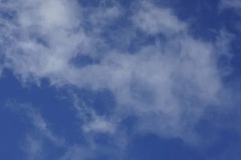 Clouds, white veil clouds in front of a blue sky Stock Photos
