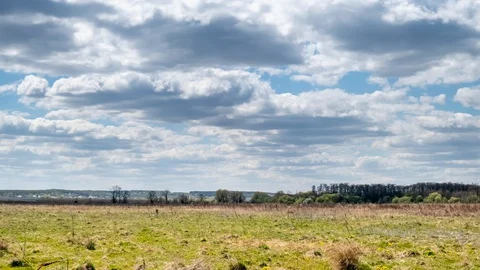 Clouds at wild field at spring. Time lapse Stock Footage 129339807
