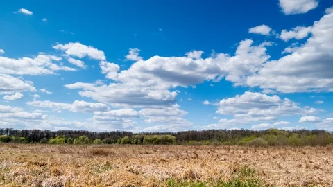 Clouds at wild field at spring. Time lapse Stock Footage 129340282