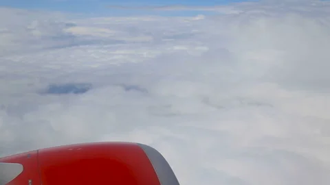Clouds from the window of an airplane, red engine. Video stock 89070540