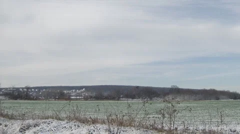Clouds with winter green field Stock Footage 983165