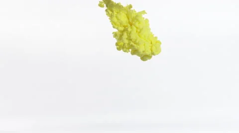 Clouds of yellow and orange ink expand downward in clear liquid, filling frame. Stock Footage 64890861