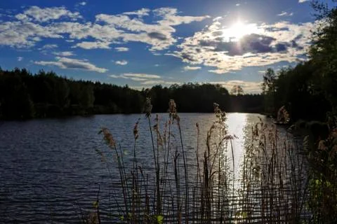 Cloudscape above the lake at sunset Stock Photos