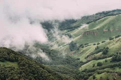 Cloudscape and mist over mountain valley. Stock Photos