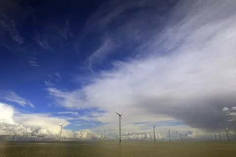 Cloudscape and wind-turbines Stock Photos