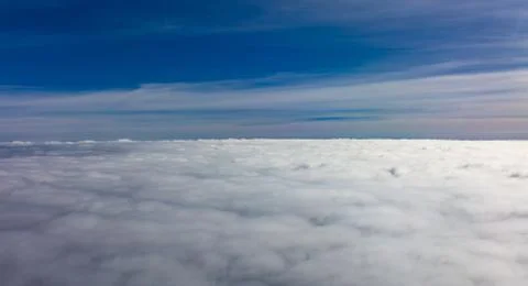 Cloudscape background. Aerial view from above, out of an airplane window. Stock Photos