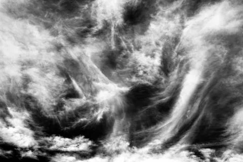 Cloudscape background texture of black and white dramatic monochrome cirrus c Stock Photos