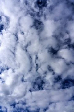 Cloudscape background texture of  white fluffy cumulus clouds with a blue sky Stock Photos