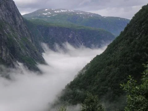 Cloudscape Between Mountain Peaks In Norway Stock Photos
