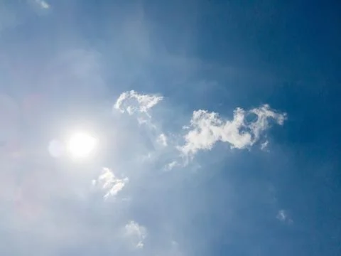 Cloudscape of Blue sky and clouds in shining sun with lens flare 스톡 사진
