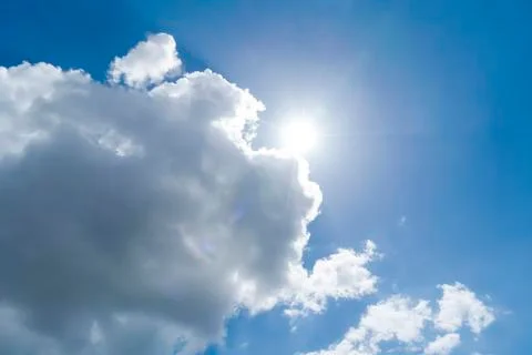 Cloudscape with blue sky and sun for backgrounds Stock Photos