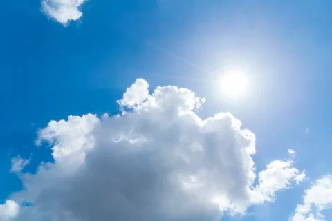 Cloudscape with blue sky and sun for backgrounds Stock Photos
