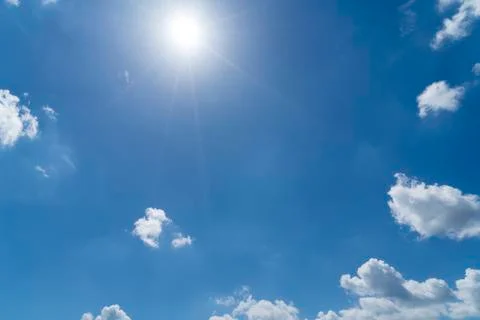 Cloudscape with blue sky and sun for backgrounds Stock Photos