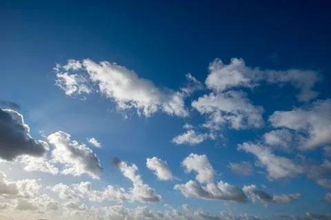Cloudscape with blue sky and sun for backgrounds Stock Photos