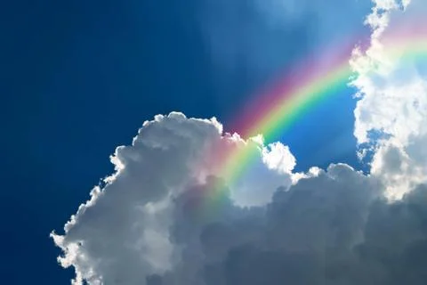 Cloudscape with blue sky and white clouds rainbow Foto stock