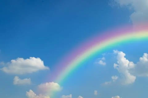 Cloudscape with blue sky and white clouds rainbow Foto stock