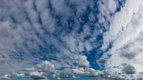 Cloudscape. Blue sky and white cumulus clouds Stock Photos