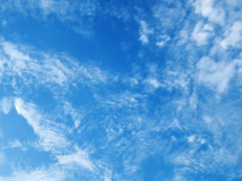 Cloudscape on blue sky. Clouds of different shapes on blue sky background. 库存照片