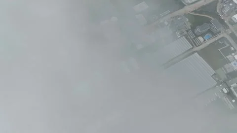 Cloudscape Chronicles: Aerial Footage of a Town in Dramatic Cinematic Shades Stock-Footage 243186570