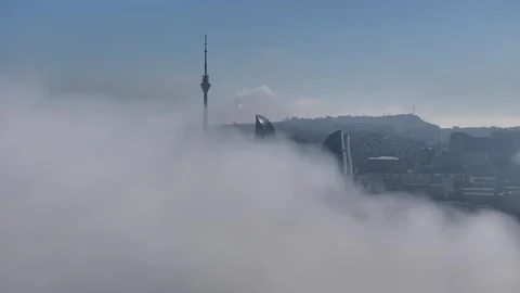 Cloudscape with Cityscape and Tall Building Through Fog Stock Footage 341883863