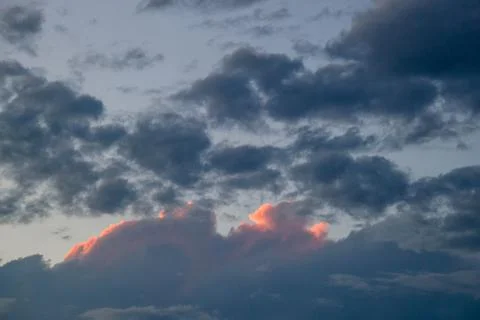 Cloudscape, Colored Clouds at Sunset near the Ocean on a Cloudy Day Stock Photos