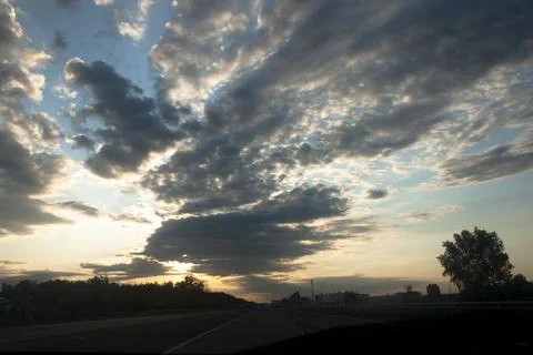 Cloudscape, Colored Clouds at Sunset near the Ocean on the Road Stock Photos