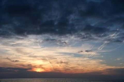 Cloudscape, Colored Clouds at Sunset near the Sea. Stock Photos