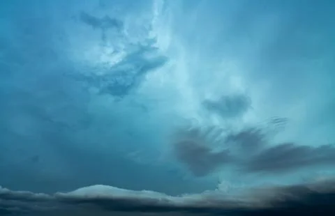 Cloudscape on dark blue sky. Blue sky and white fluffy clouds. Peaceful and t 库存照片
