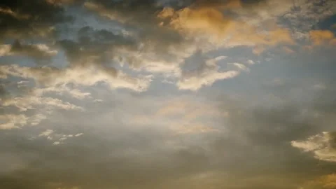 Cloudscape at dawn with warm golden highlights Video stock 316796095