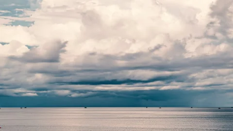 Cloudscape Evolution Over Calm Sea. Majestic Clouds Drifting Gracefully Over Stock Footage 313714953
