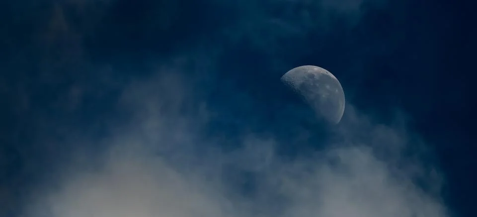 Cloudscape with half moon Stock Photos