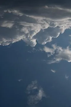 Cloudscape. Massive cumulus clouds illuminated by the sun Stock Photos