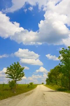 Cloudscape over rural road Stock Photos