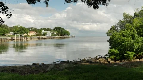 Cloudscape Pan left View east from Point Pinellas Bay Vista Park over rocks and Stock Footage 284727437