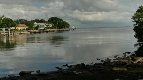 Cloudscape Pan up View east from Point Pinellas Bay Vista Park over rocks and bl Stock Footage 284727438