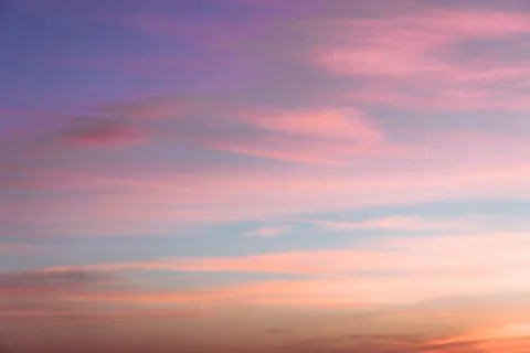 Cloudscape with pink fluffy clouds in sunset sky Foto stock