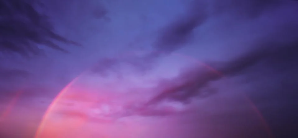 Cloudscape with rainbow on dramatic sky at sunset Stock Photos