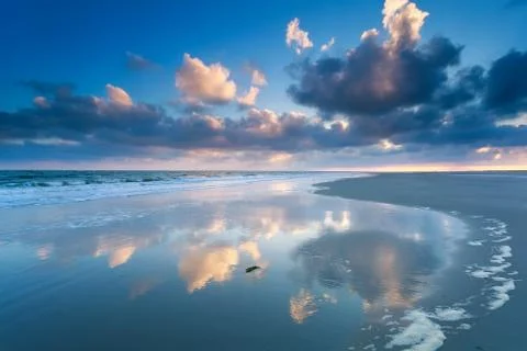 Cloudscape reflected in North sea waves Stock Photos