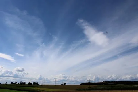 Cloudscape in the sky over a landscape Stock Photos
