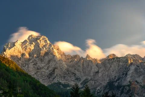 Cloudscape in sunset above mountain ridge Stock Photos