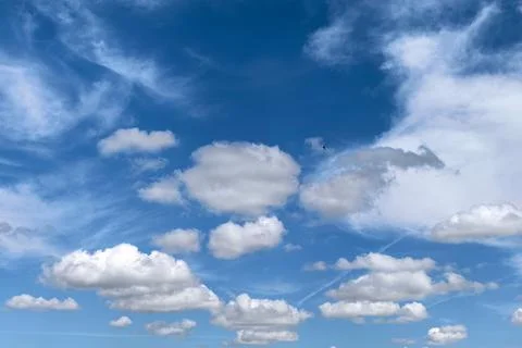 Cloudscape With Swallow Flying Across Blue Sky Stockfoto's