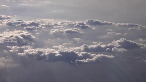 Cloudscape view with colorful flecks of sunlight on aircraft window. 4K 스톡 동영상 72707060